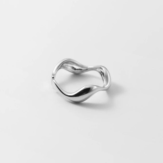 Close-up of the silver Golden Wave Stackable Ring, highlighting its elegant wave design and adjustable feature.