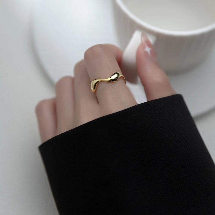 Model's hand showcasing the gold-plated Golden Wave Stackable Ring, adding a touch of sophistication to her look.