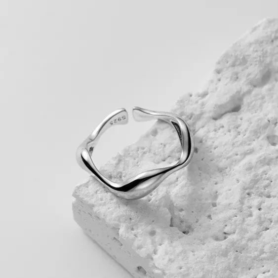 Silver Golden Wave Stackable Ring displayed on a white background, showcasing its sleek, adjustable design with a subtle wave shape.