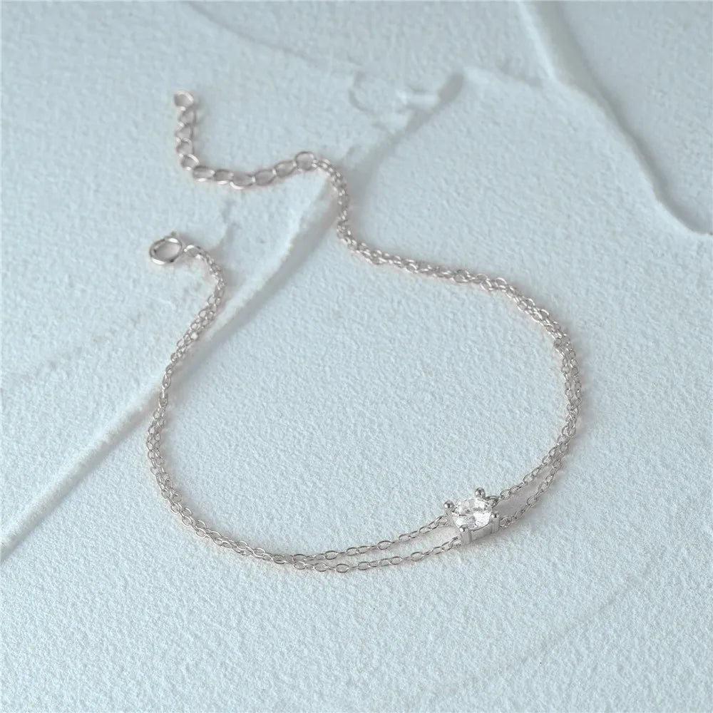 Adjustable silver dual chain bracelet with a modern and refined look.