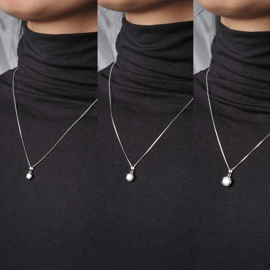 Silver necklace with a moissanite pendant worn by a model