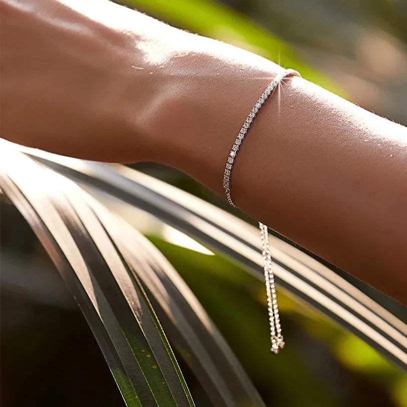 Adjustable sliding clasp on the silver tennis bracelet for a comfortable fit.