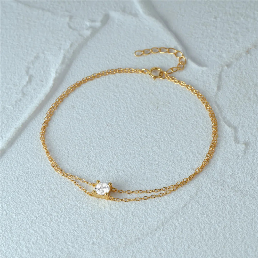 Gold-plated dual chain bracelet with an adjustable clasp for a perfect fit.
