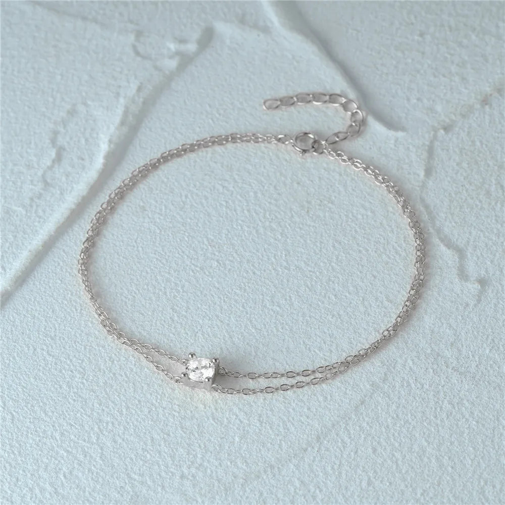 Elegant silver bracelet featuring a layered chain design.