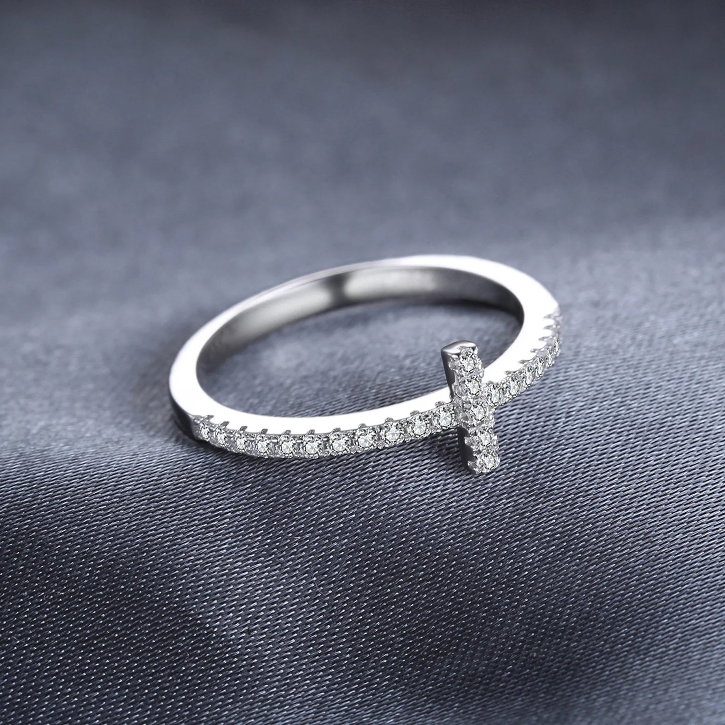 Sterling silver ring with cross design and sparkling cubic zirconia stones.