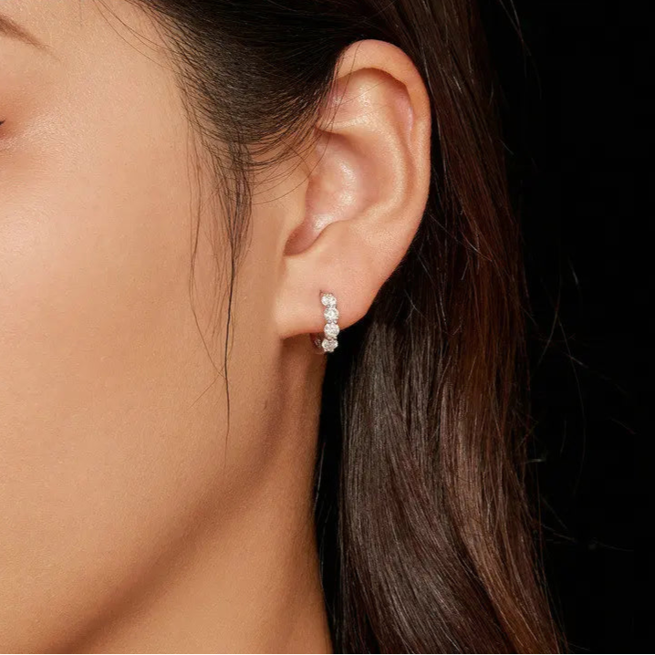 Girl wearing Luminous Glow Huggie Hoops, showing their close-fitting and stylish look.