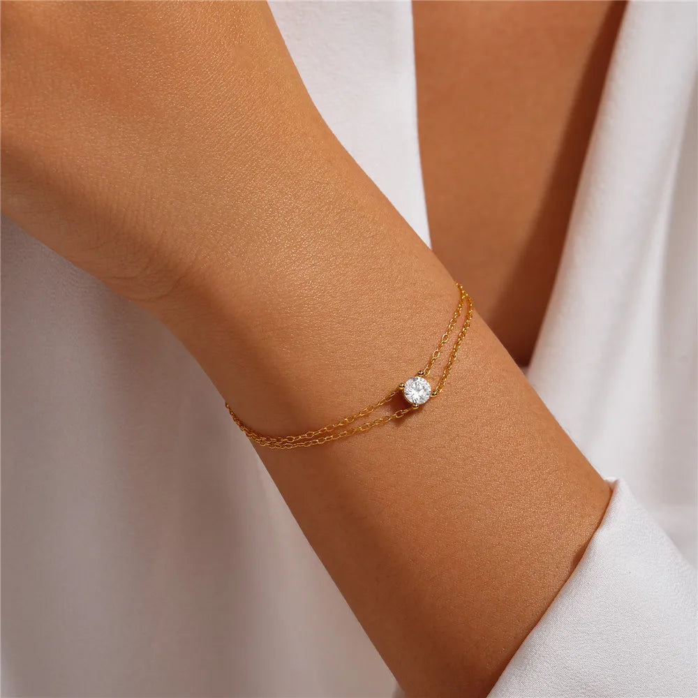 Close-up of the sleek dual chain gold bracelet with a delicate and minimalist design.