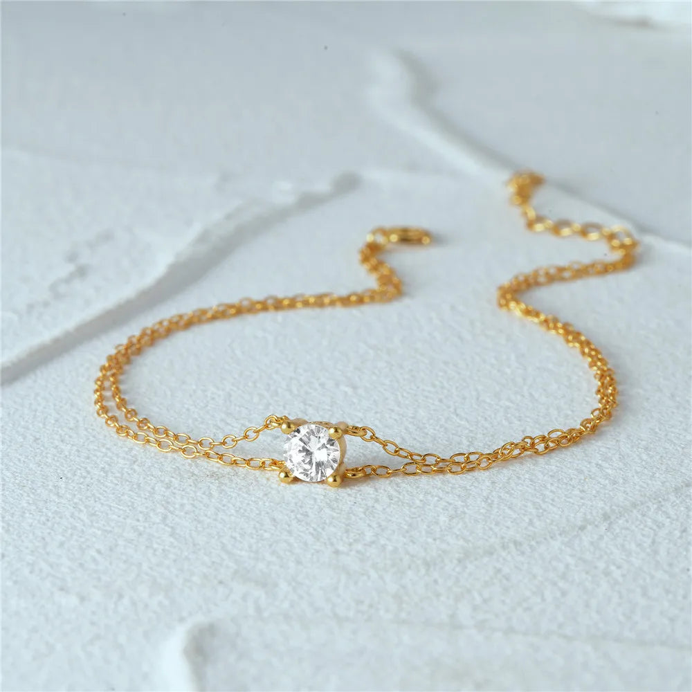 Minimalist gold bracelet featuring a double chain design for a modern touch.