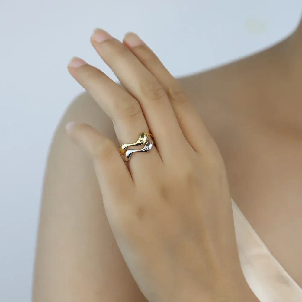 Model showcasing the stacked Golden Wave rings in silver and gold-plated finishes, creating a chic and layered look.