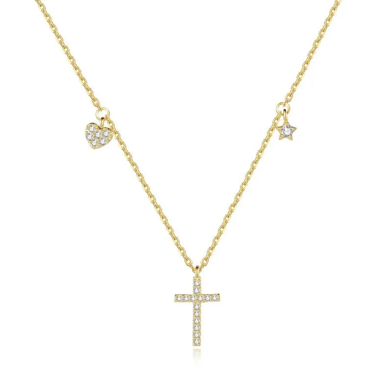 The Luminous Cross Necklace in gold, elegantly presented with its heart, star, and cross charms adorned with cubic zirconia.