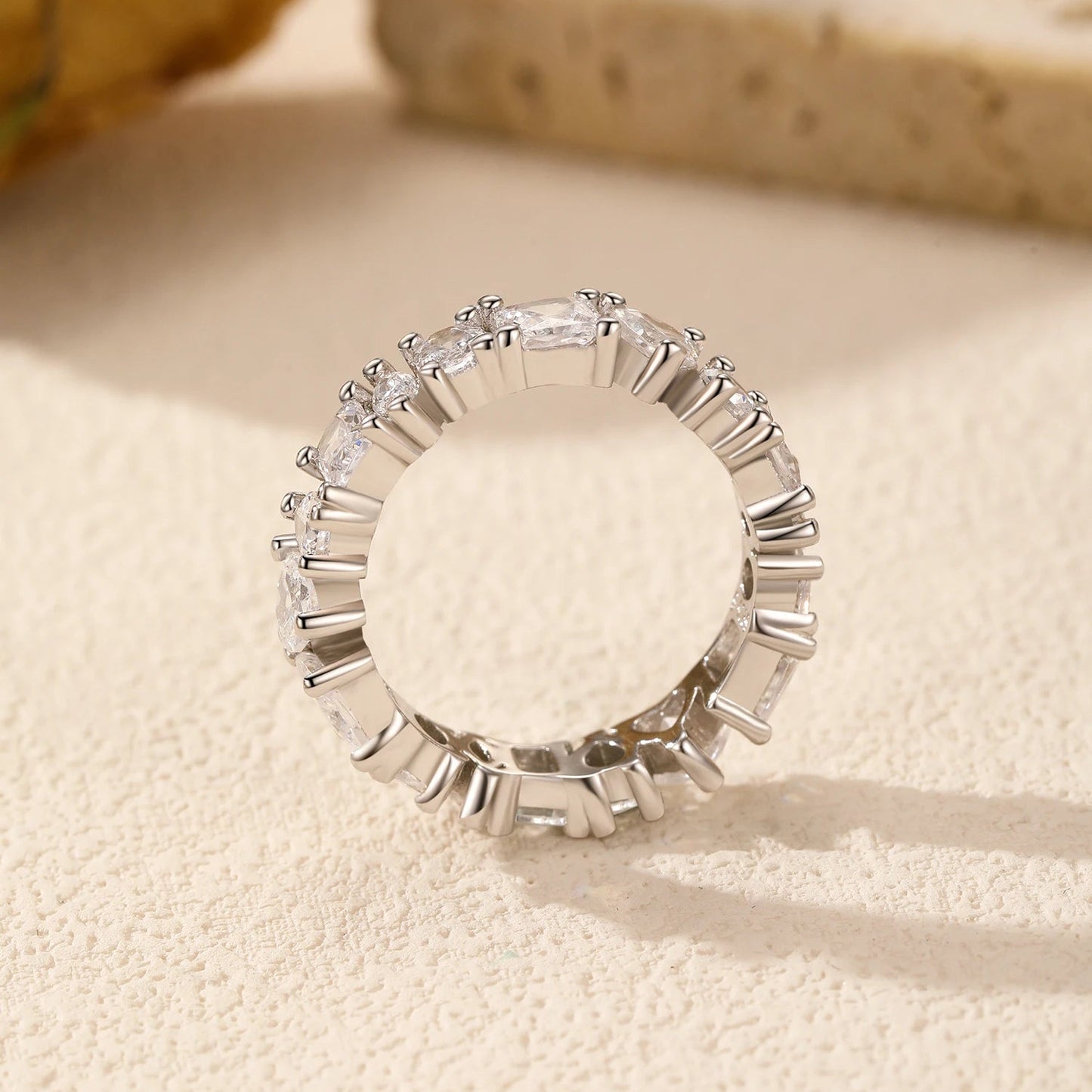 Side view of the Luna Stacking Band, showcasing its sleek profile and sparkling cubic zirconia stone in a polished silver setting.