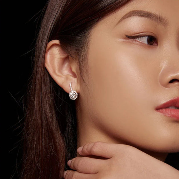 Model wearing Radiant Halo Moissanite Earrings, highlighting their elegant fit.