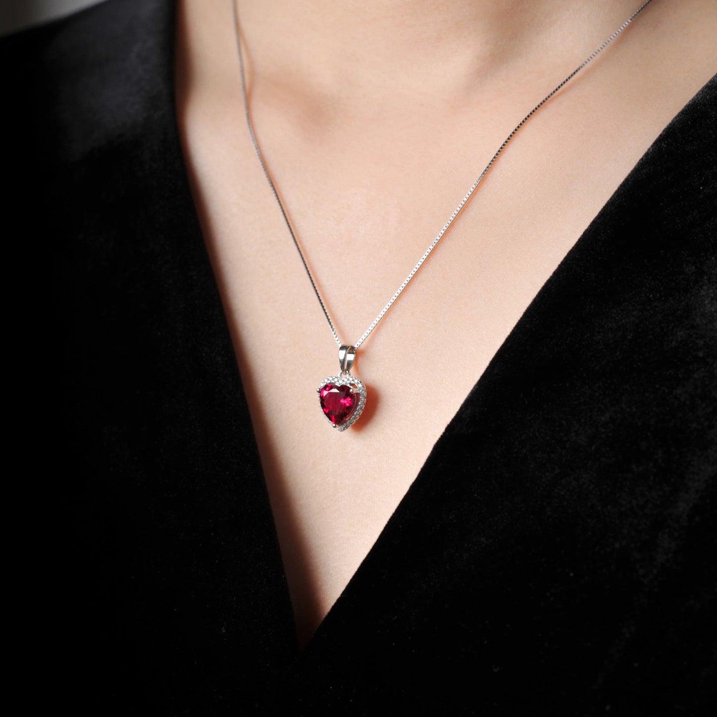 Model wearing the Ruby Love Silver Pendant, showcasing its elegant heart-shaped ruby and cubic zirconia halo.