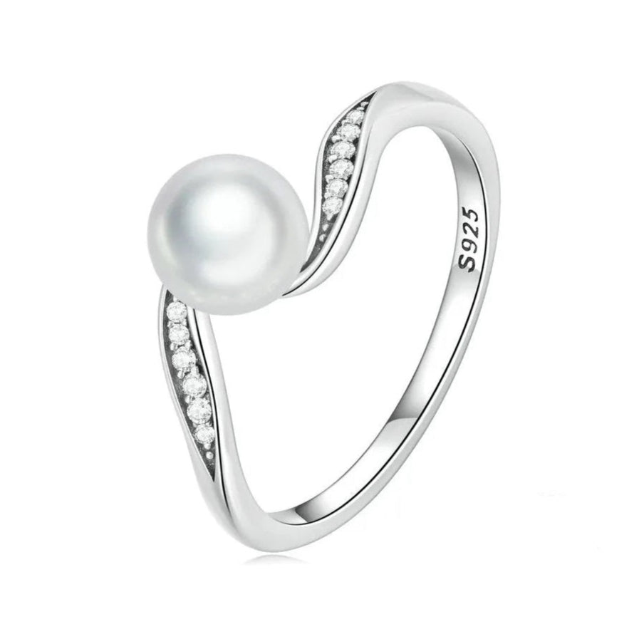 Close-up of pearl centerpiece surrounded by cubic zirconia on oxidized silver wave ring