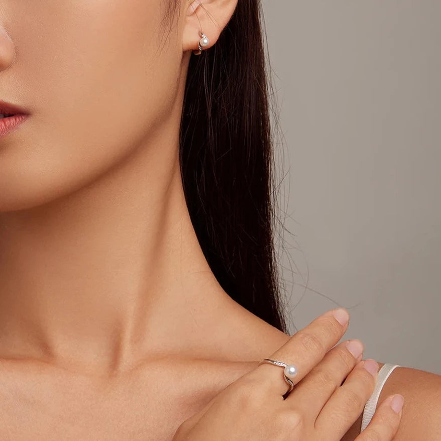 Pearl Elegance Silver Ring worn on hand showcasing elegant wave design and shimmering stones