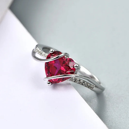 Elegant heart-shaped ruby ring crafted in 925 sterling silver with sparkling accents.