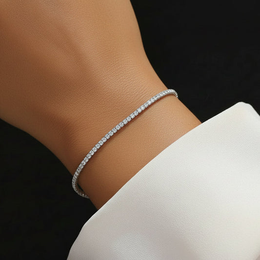 A model wearing the Essential Tennis Bracelet in Rhodium-plated 925 silver for a delicate, everyday look