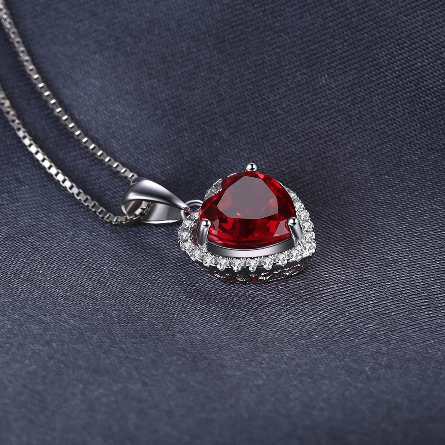 Close-up of the Ruby Love Silver Pendant showcasing its radiant heart-shaped ruby and shimmering details.