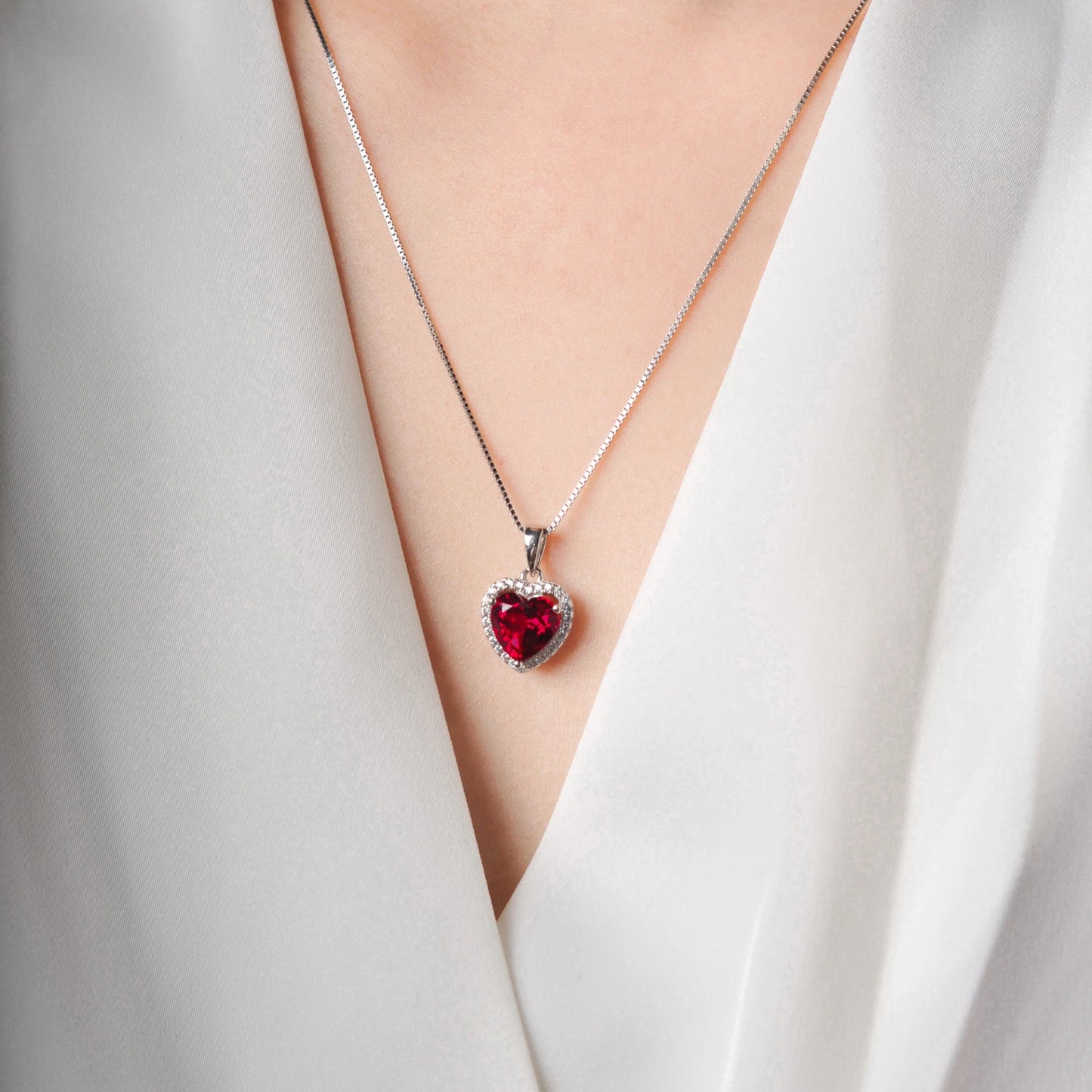Ruby Love Silver Pendant elegantly displayed on a model, highlighting its vibrant red lab-grown ruby and sterling silver setting.