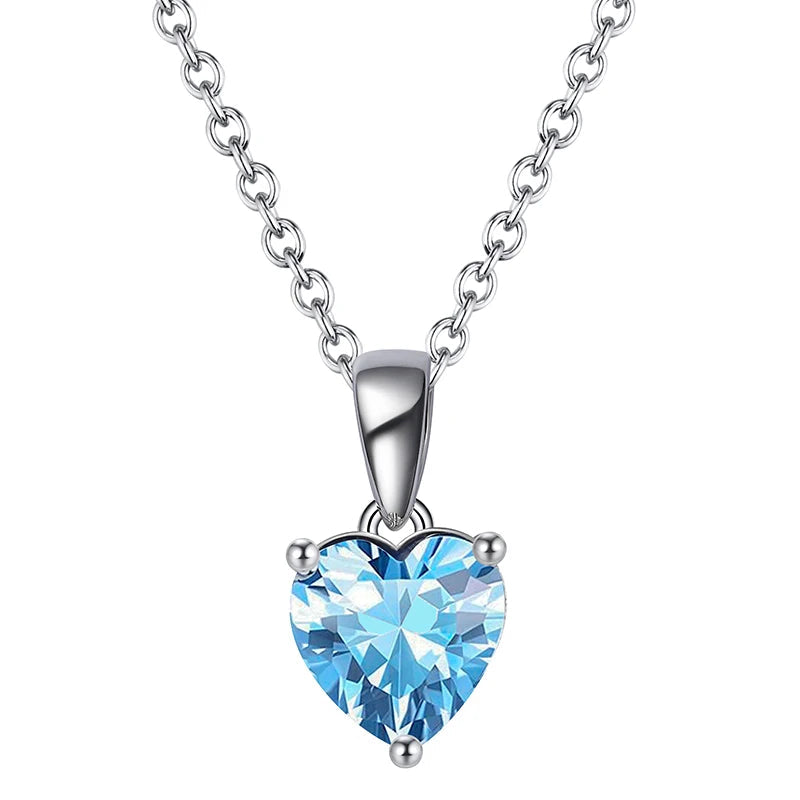 Silver heart necklace with Celestial Aqua cubic zirconia pendant, a delicate light blue birthstone piece.