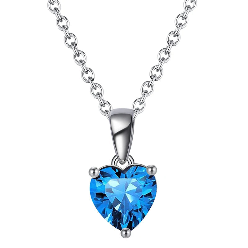 Silver heart necklace featuring a Sapphire Glow cubic zirconia stone, radiating a deep blue brilliance.