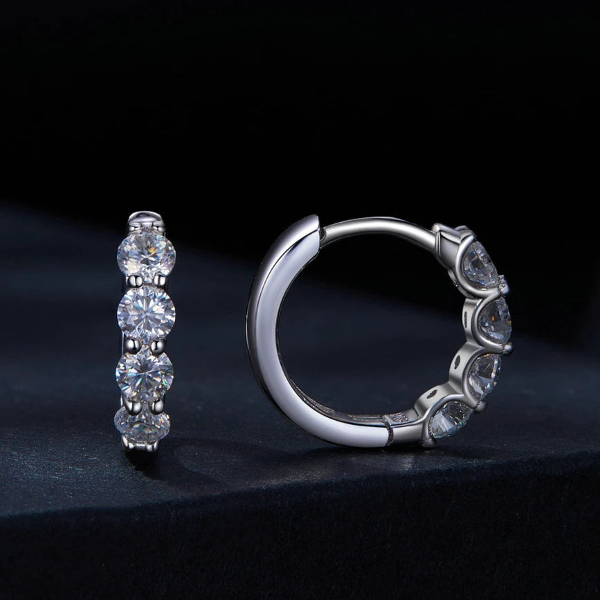 Small, round huggie hoops designed for a comfortable and stylish fit.