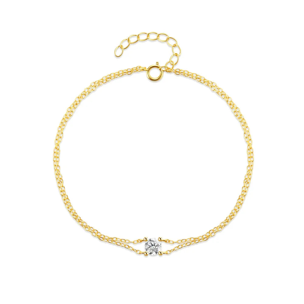 Elegant gold-plated dual chain bracelet displayed on a white background.