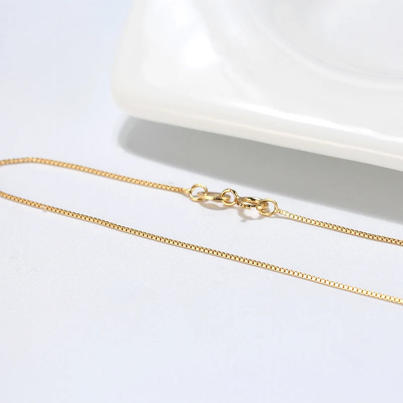 Sleek gold box chain with a smooth structure and timeless appeal.