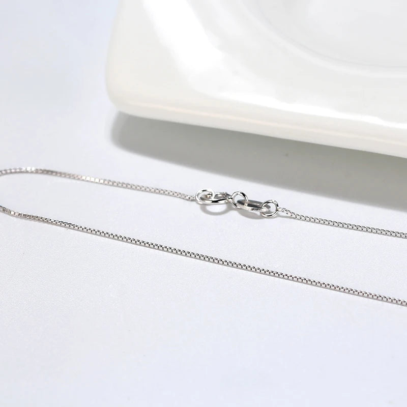 Delicate silver box chain with a spring ring clasp, perfect for layering.