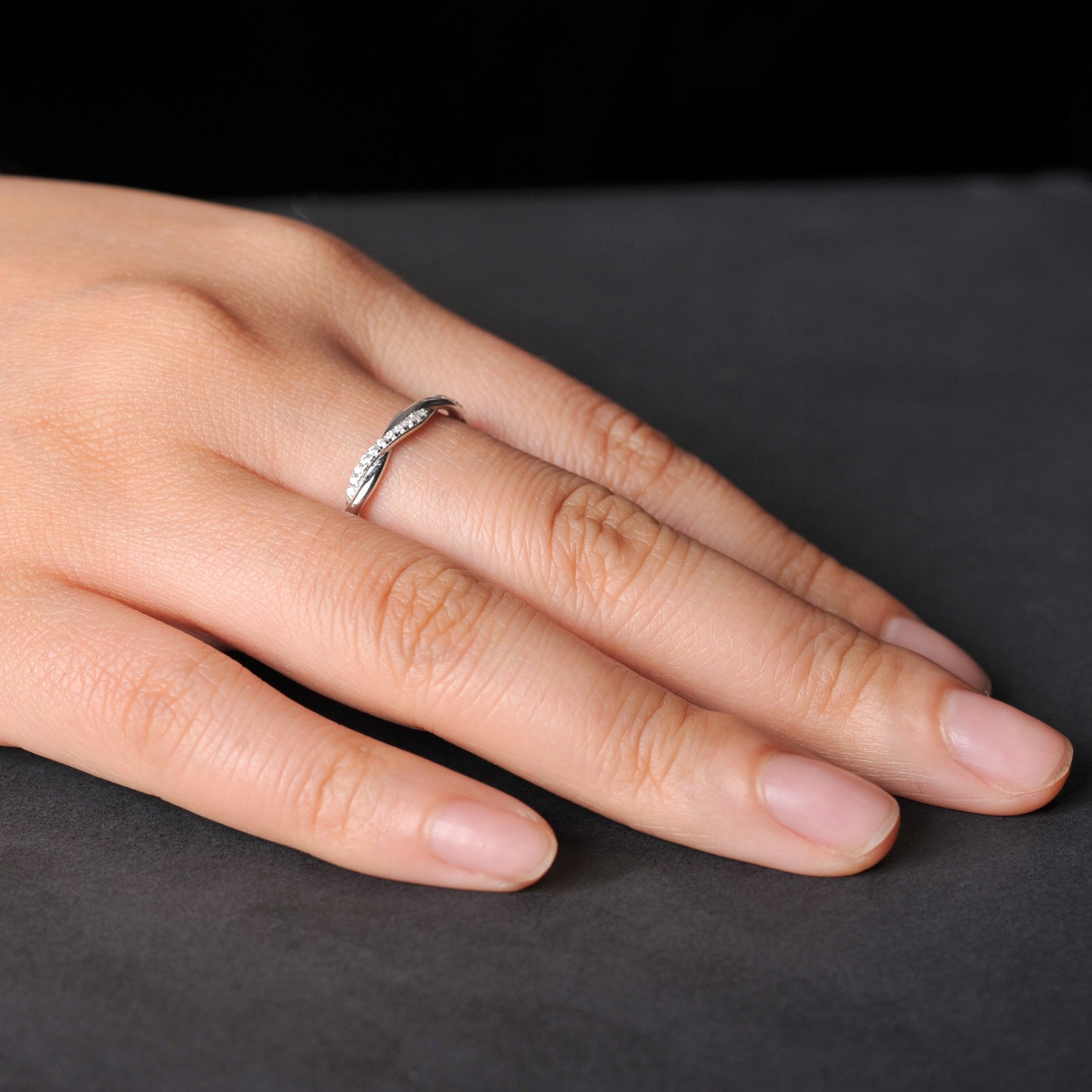 Sleek infinity cascade silver band ring with brilliant moissanite accents.