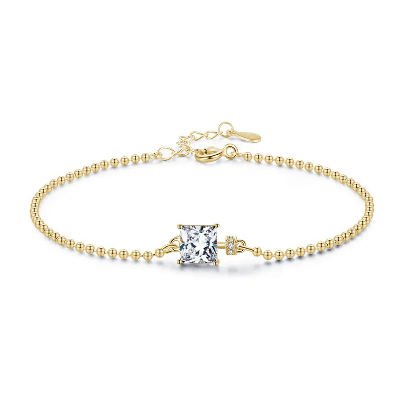 Elegant square stone gold-plated bracelet with cubic zirconia, featuring a square-cut stone in a refined setting.
