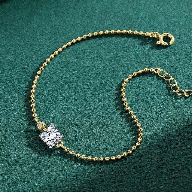Square stone gold-plated bracelet with a shimmering cubic zirconia stone, adding a touch of sophistication.