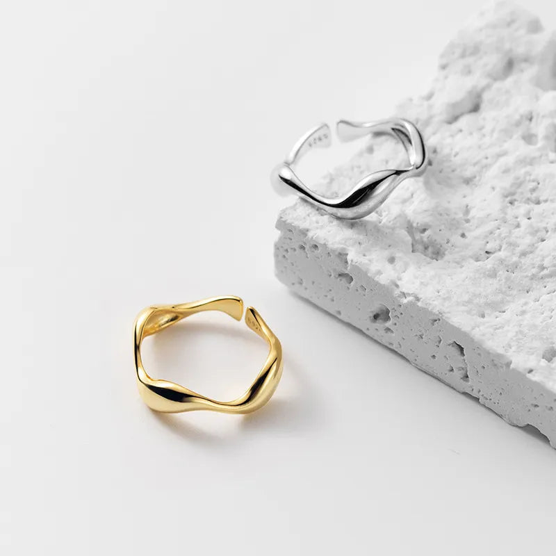 Golden Wave stackable rings in silver and gold-plated finishes displayed together, showcasing their elegant and adjustable design.