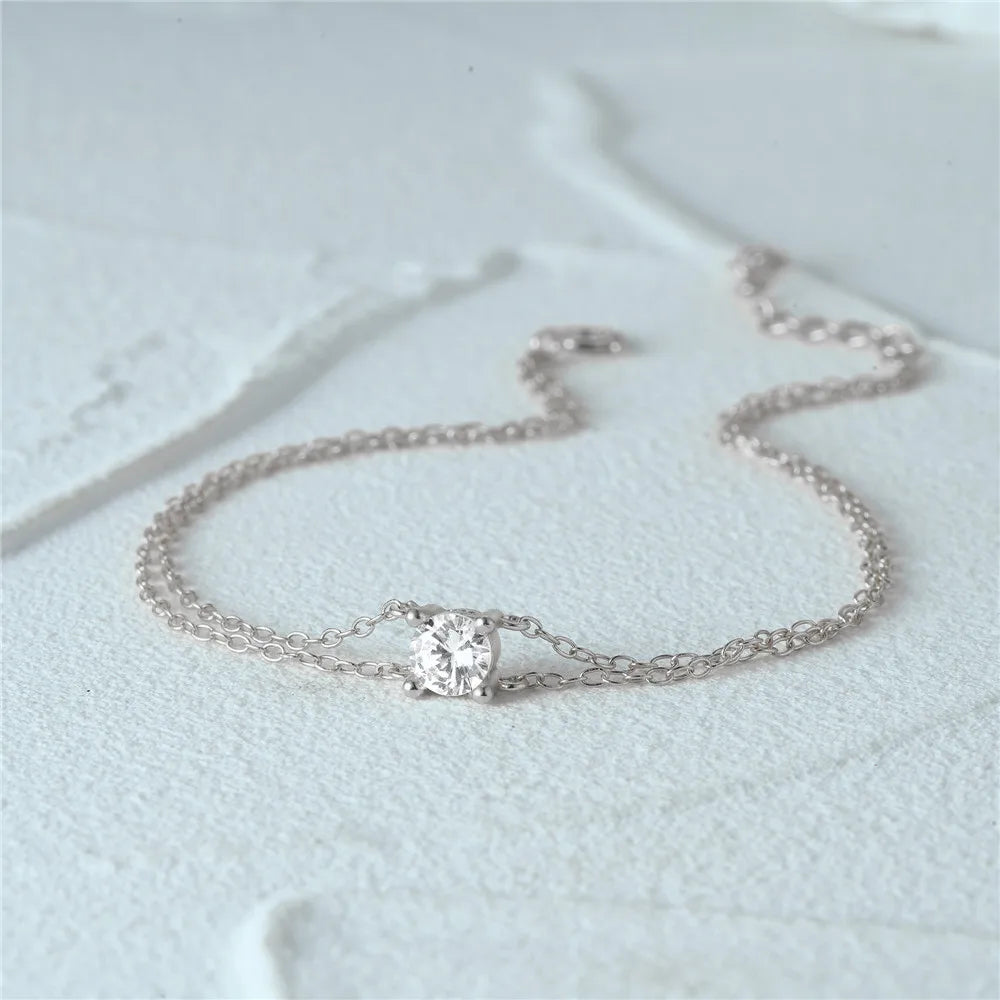 Minimalist sterling silver bracelet with a double-chain structure.