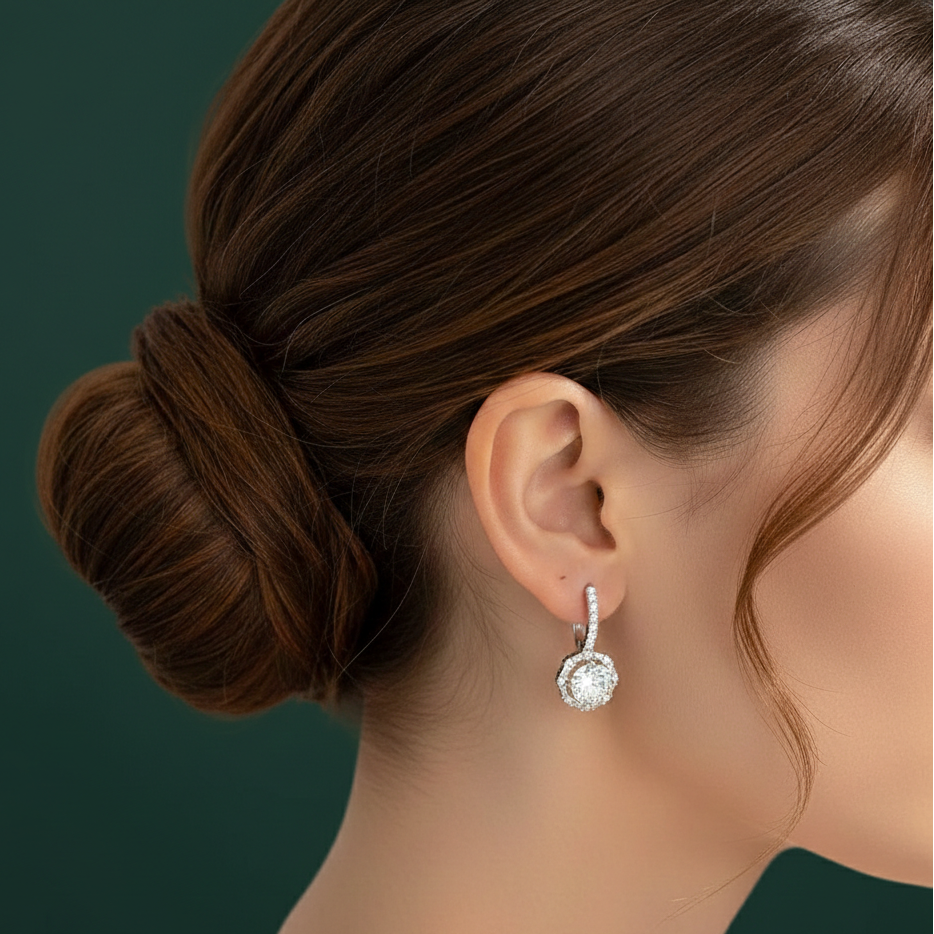 Lifestyle image of a model wearing Versailles moissanite earrings, demonstrating the high-refractive brilliance of the mixed-cut halo