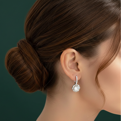 Lifestyle image of a model wearing Versailles moissanite earrings, demonstrating the high-refractive brilliance of the mixed-cut halo