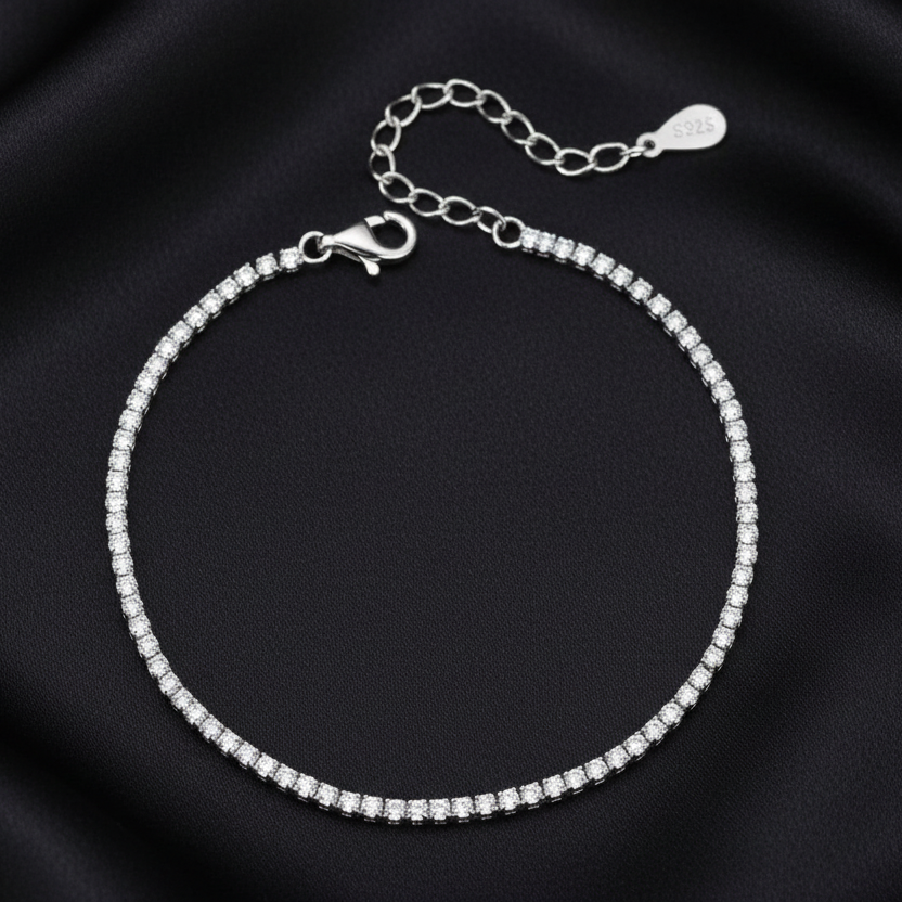 Close-up of the adjustable lobster clasp and extender chain on a silver tennis bracelet