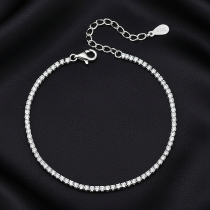 Close-up of the adjustable lobster clasp and extender chain on a silver tennis bracelet