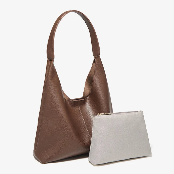 Contemporary leather bag with a single strap and secure closure.