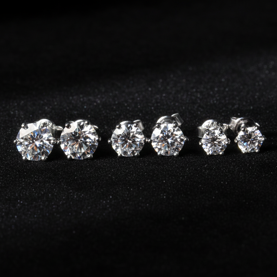 Set of moissanite stud earrings on a black background