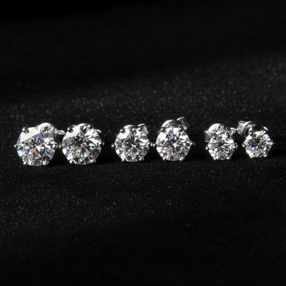 Set of moissanite stud earrings on a black background