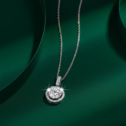 Luxury flatlay of the Celeste Round Halo Necklace on a dark green background highlighting the D-VVS1 brilliance