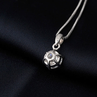 Silver pendant necklace from the back on a black fabric background