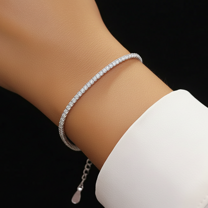 Lifestyle view of a model wearing the rhodium-plated 925 sterling silver Essential tennis bracelet for a classic look