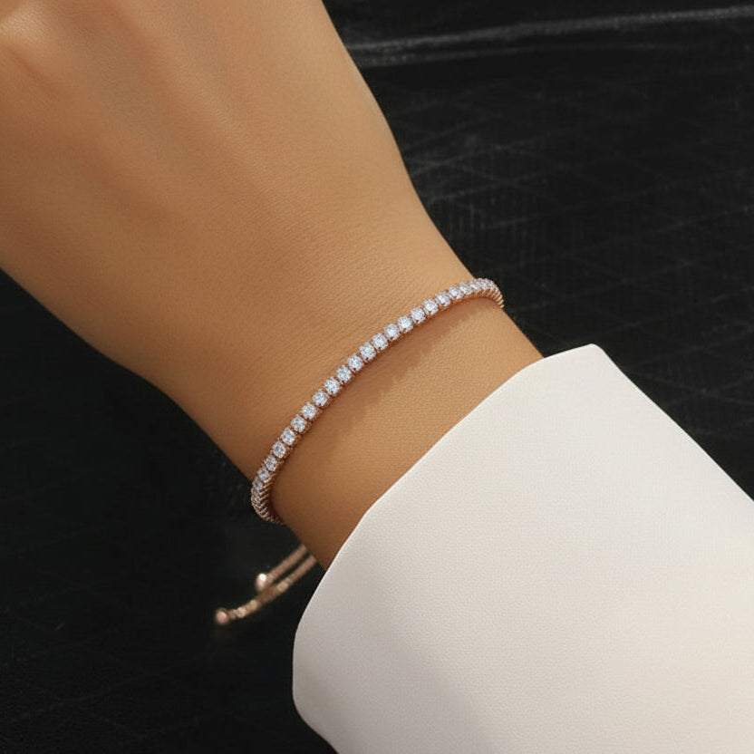 Model wearing the Essential 18K rose gold tennis bracelet to show the delicate 2.0 mm stone size on the wrist