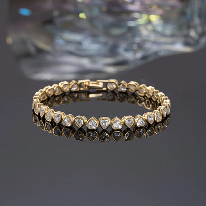 Gold-plated heart tennis bracelet with delicate heart-shaped stones for a romantic look.