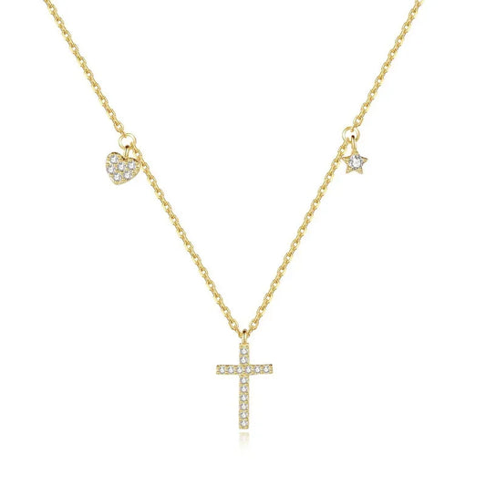 The Luminous Cross Necklace in gold, elegantly presented with its heart, star, and cross charms adorned with cubic zirconia.