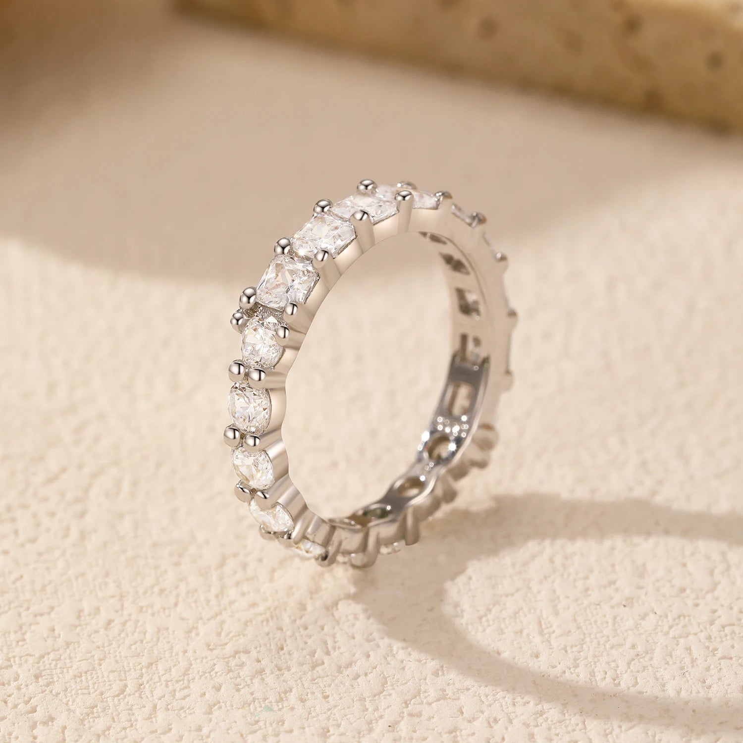 Side angle of the Luna Stacking Band, showcasing its round cubic zirconia stone and smooth silver finish.