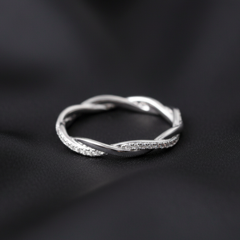 Silver ring on a black fabric background