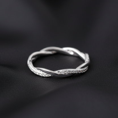 Silver ring on a black fabric background